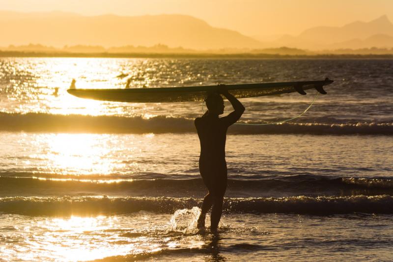 Surfer at sunset, Byron Bay